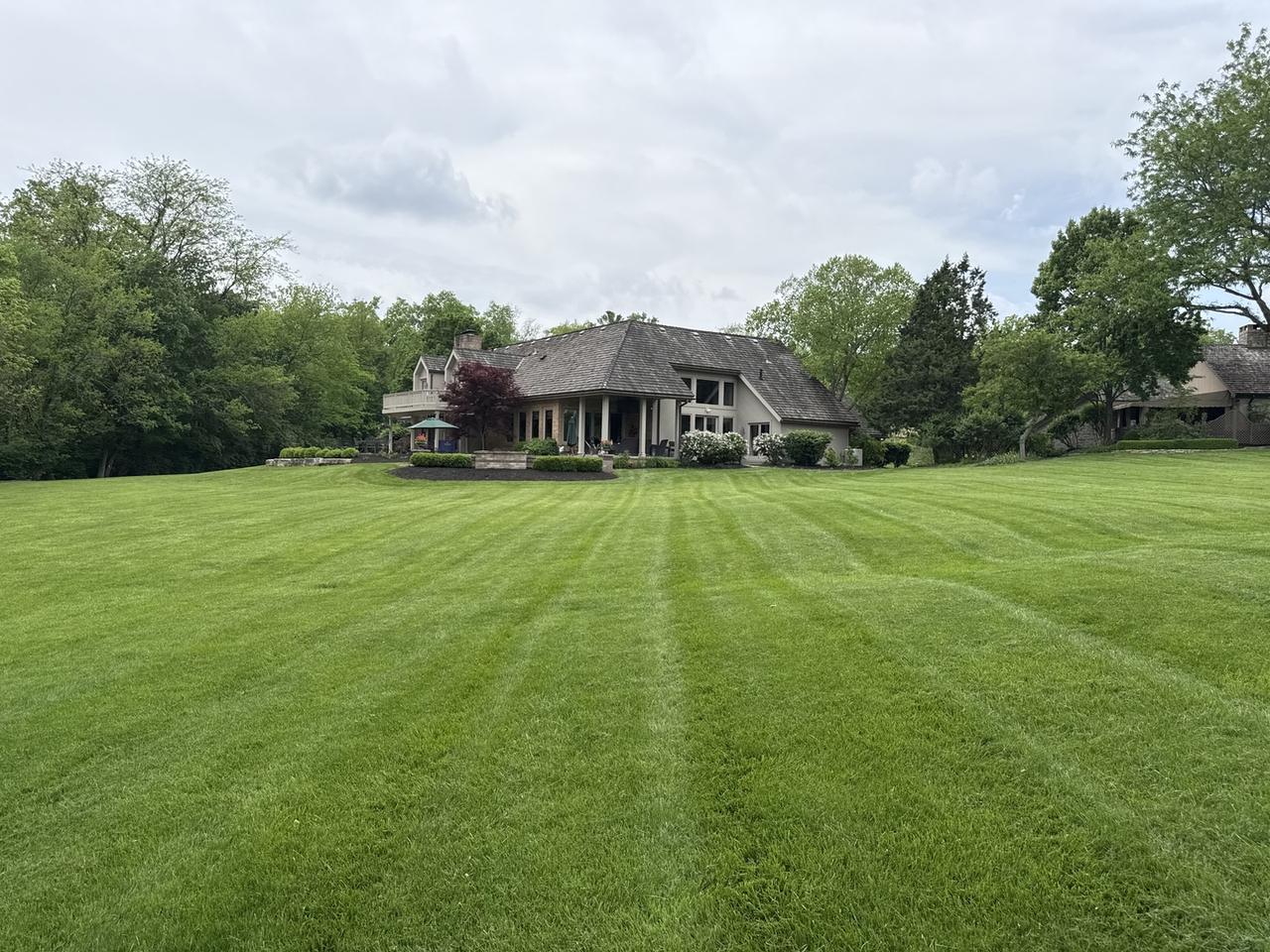 Large striped lawn freshly mowed by Hole in 1 Lawn Care at a central Ohio estate property